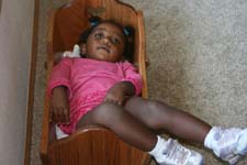 baby in a doll crib